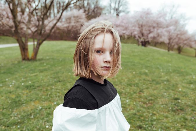 Cute girl near blooming trees