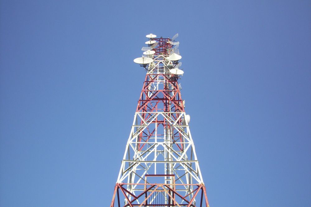 Tall Communication Tower With Clear Blue Sky Background