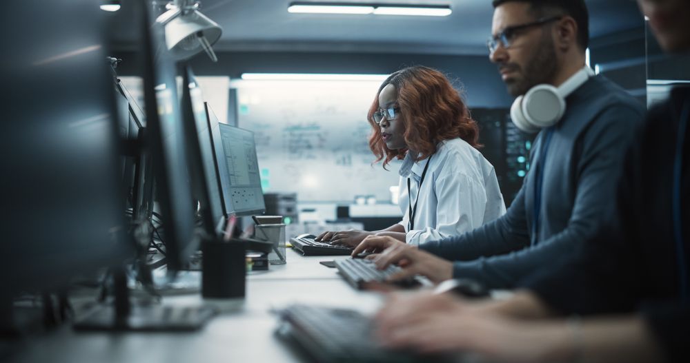 Portrait of a Thoughtful Black Female Engineer Working on Computer in a Technological Office Environment.