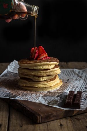 Pancake with strawberries and chocolate covered in syrup