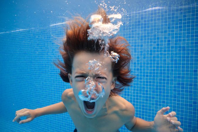 Furious boy yelling in swimming pool