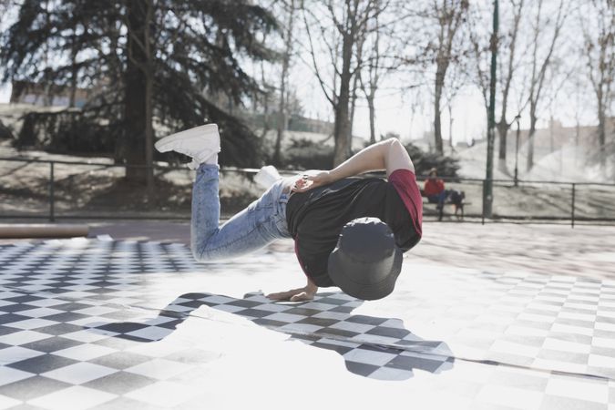 Man dancing break dance in park