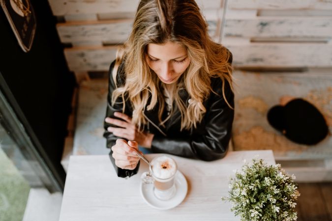 Woman drinking coffee from a glass
