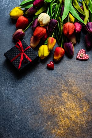 Top view of counter with tulips and giftbox 