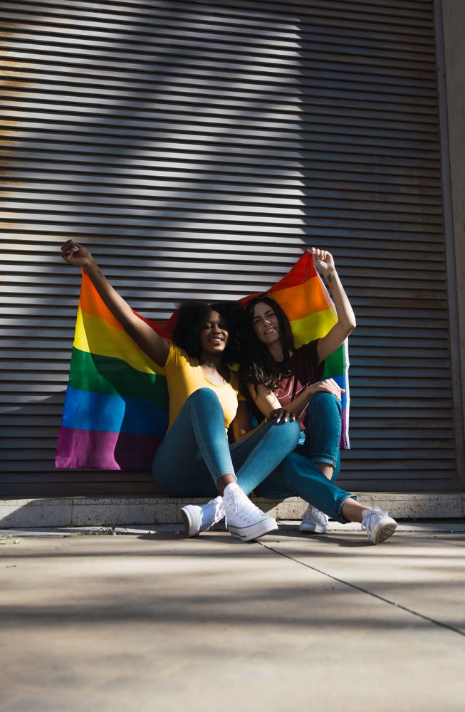 Female couple with LGBT flag