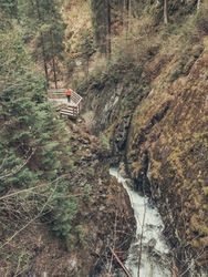Traveller admiring picturesque view of mountain stream