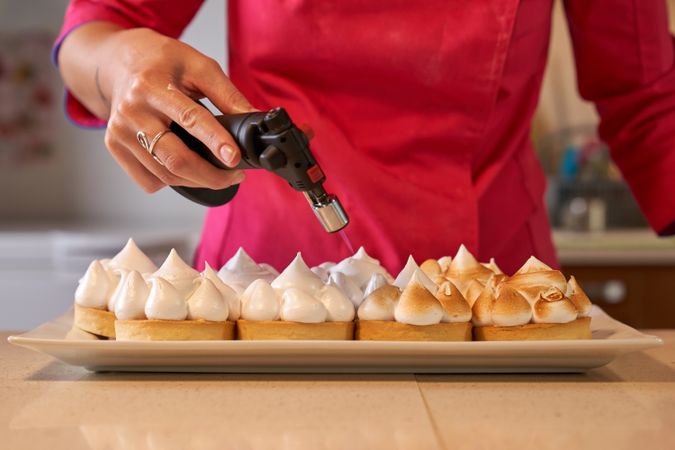 Confectioner hand burning Swiss meringue