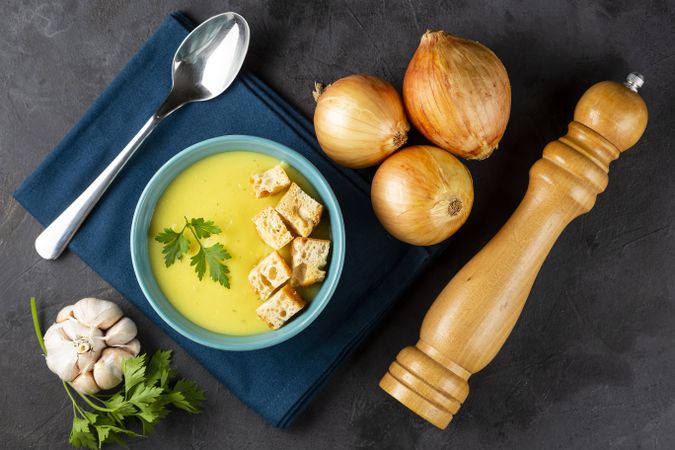 Bowl with onion soup and croutons on the table.