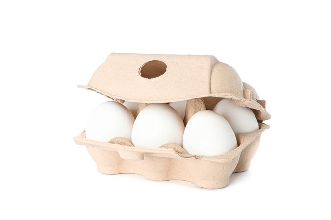 chicken eggs in carton box isolated on blank background