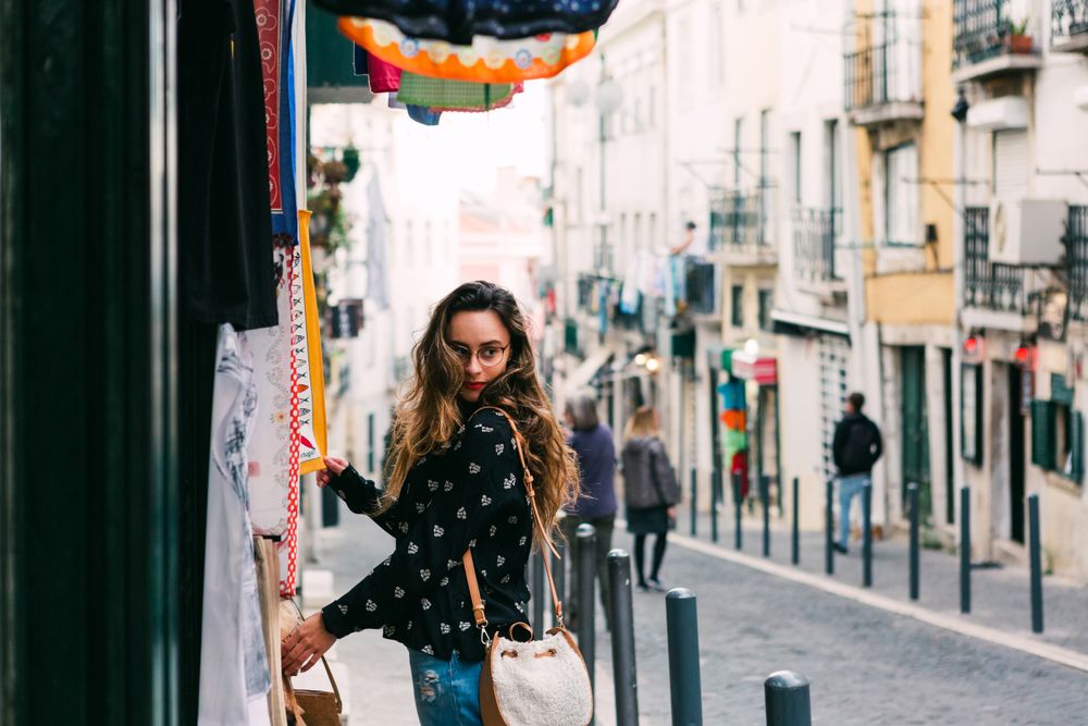 woman exploring street stall with clothes