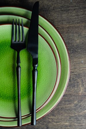 Spring table setting of three green plates