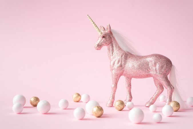 Pink glitter unicorn with gold and light-colored decorations