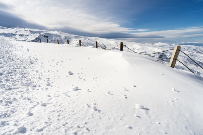 Snowy fence in ski resort of Sierra Nevada in winter