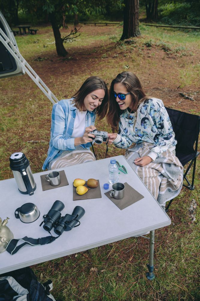 Woman showing photo of friend at breakfast