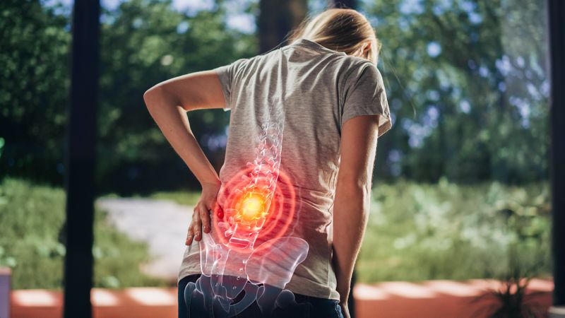 VFX Back Pain Augmented Reality Render. Close Up of a Female Experiencing Discomfort in a Result of Spine Trauma or Arthritis.