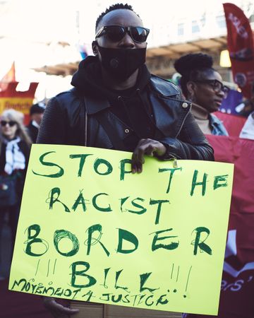 London, England, United Kingdom - March 19 2022: Black man holding sign at anti-racist protest