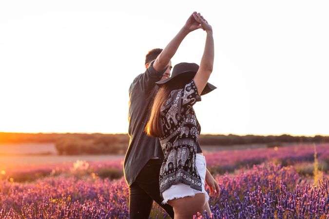 A romantic photograph of a couple in a lavender field