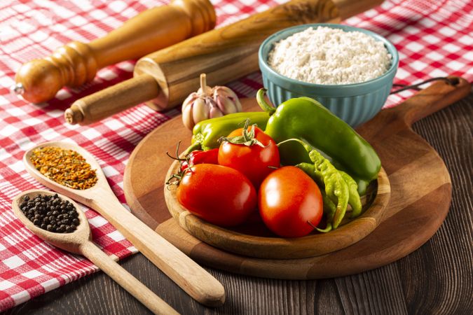 Wooden table with ingredients for pizza.