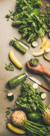 Smoothie ingredients, avocado, banana, zucchini,  on grey table, vertical composition