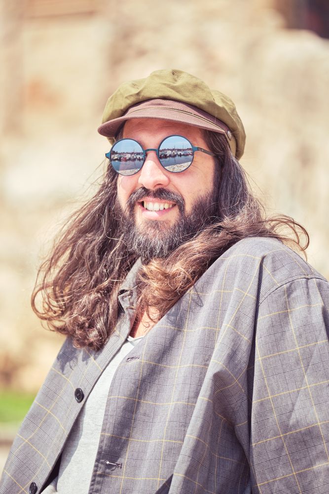 Happy man in cap on street