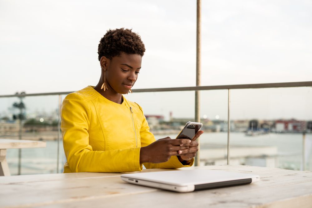 Focused woman using mobile at desk