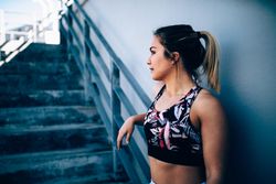 Young woman resting on stadium stairs