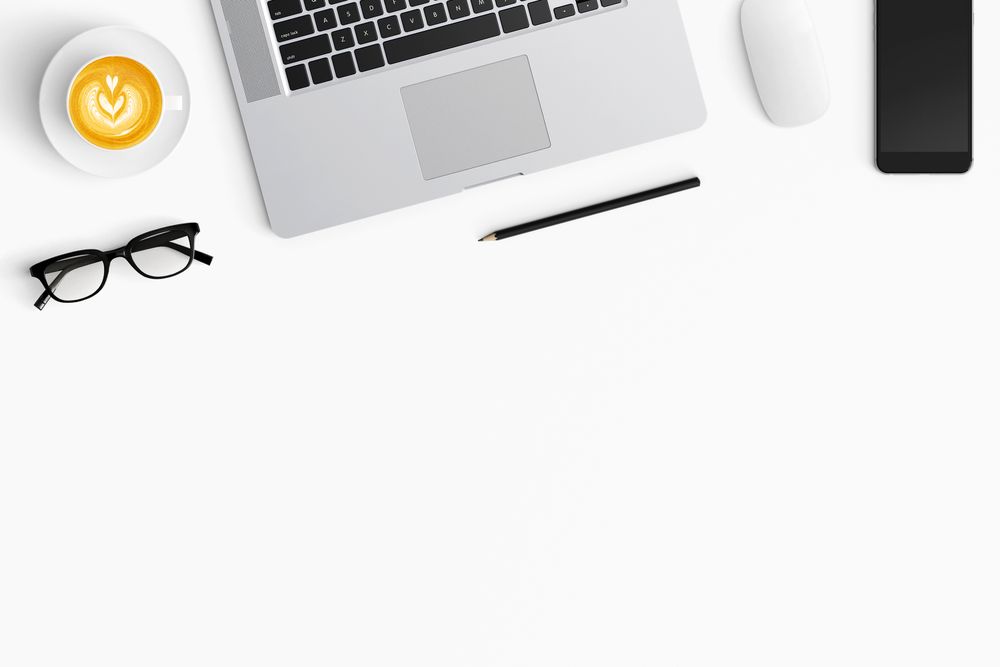 Modern workspace with coffee cup, smartphone, paper, notebook, tablet and copy space