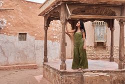 Woman dancing on street stage between ancient buildings