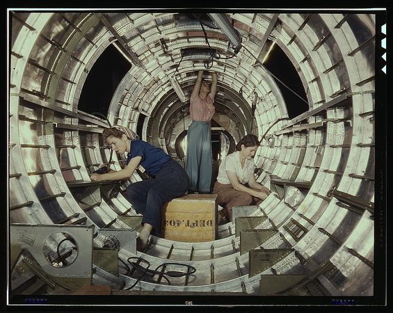 Long Beach, CA, USA - 1942: Female mechanics working inside a bomber