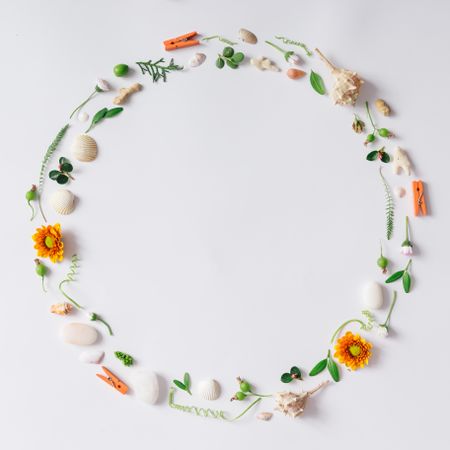 Circle made with summery items like flowers and seashells
