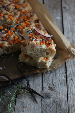Pieces of fresh focaccia on wooden table