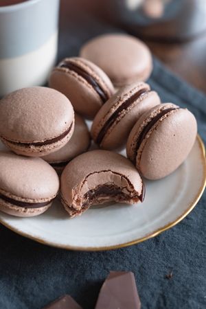 Chocolate French macarons with bite taken from one