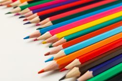 Colorful pencils on blank background, close up