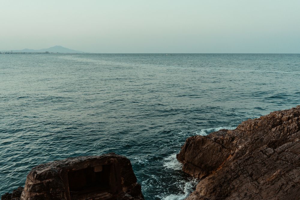 Sea waves hitting rocky cliff