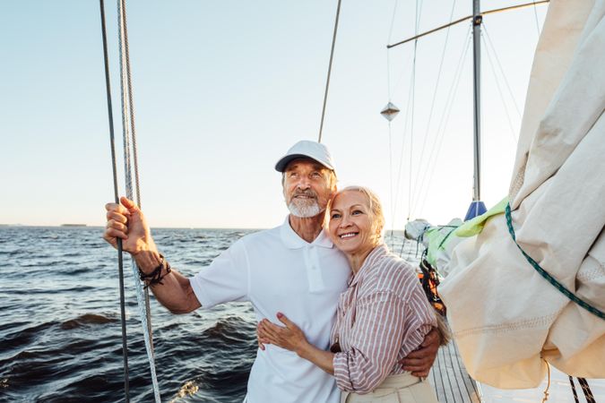Older couple standing together on sailboat