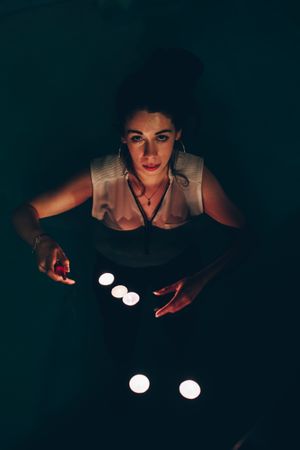 Woman swimming in pool with candles