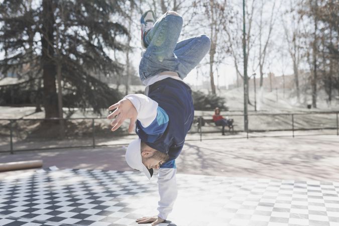 Man dancing break dance in park