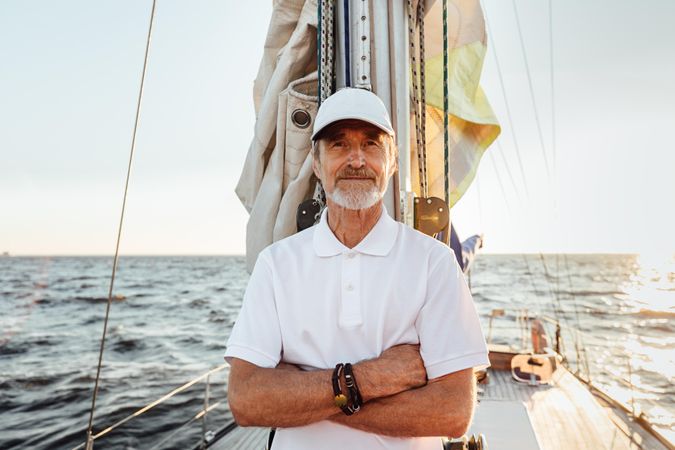 Portrait of older man with arms cross on his sailboat