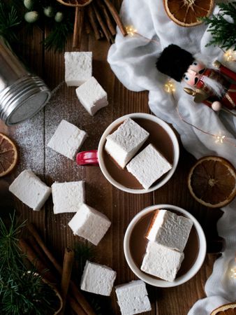 Spices and decorations near hot chocolate with marshmallows