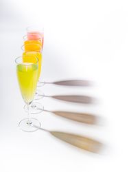 Glasses of bright colorful drinks on table