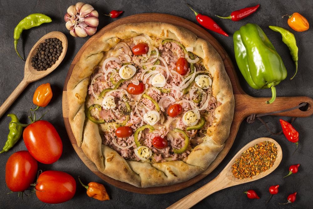 Empty pizza  board on the table with Ingredients for cooking