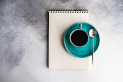 Top view of coffee cup and notepad