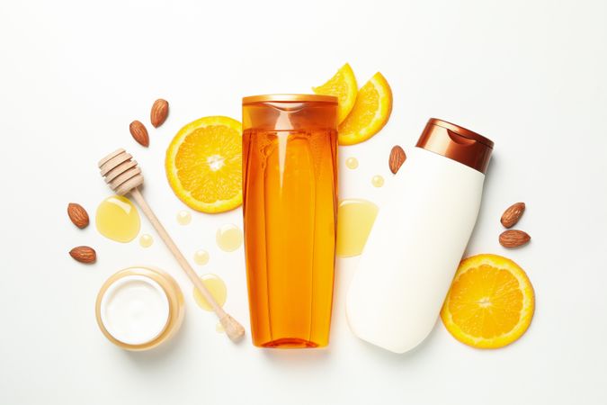 Flat lay with cosmetics and natural ingredients on light background