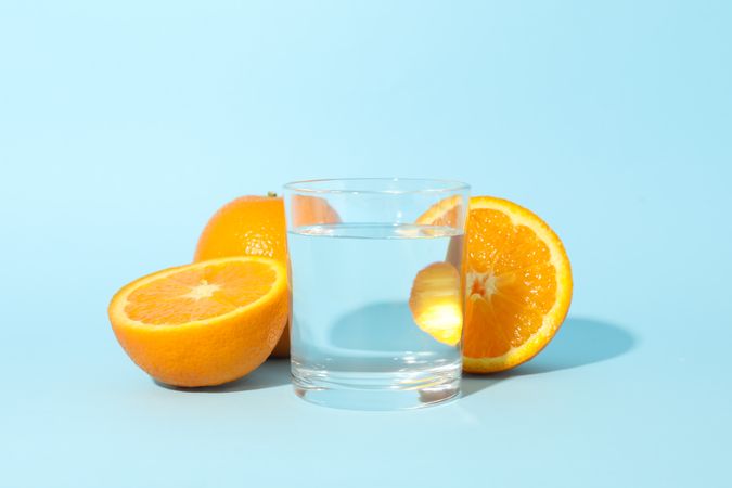 Glass of water with orange halves