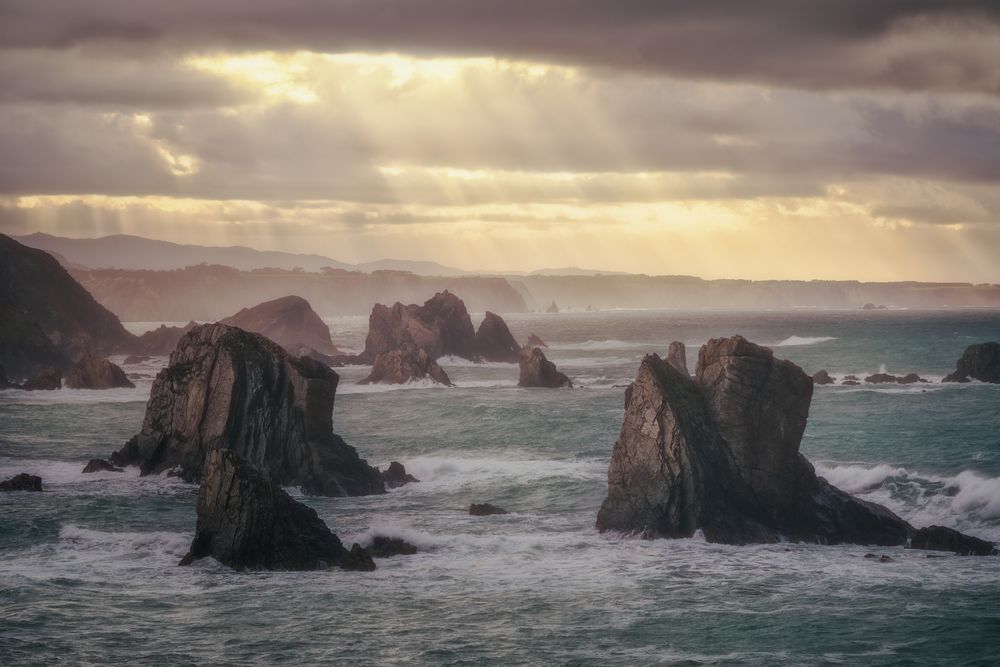 Coastal rock on beach and overcast sky