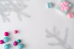 Christmas decorations, gifts with shadows on corners of light background