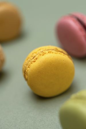 Close up of yellow macaroon on a marble background