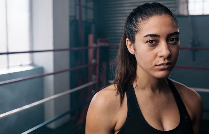 Portrait of female athlete in boxing ring