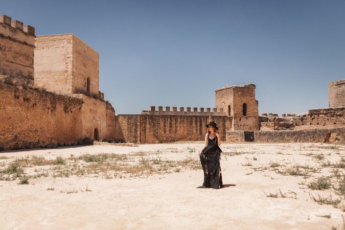 Elegant female walking in ancient fortress