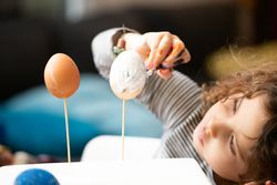 Girl painting eggs at home